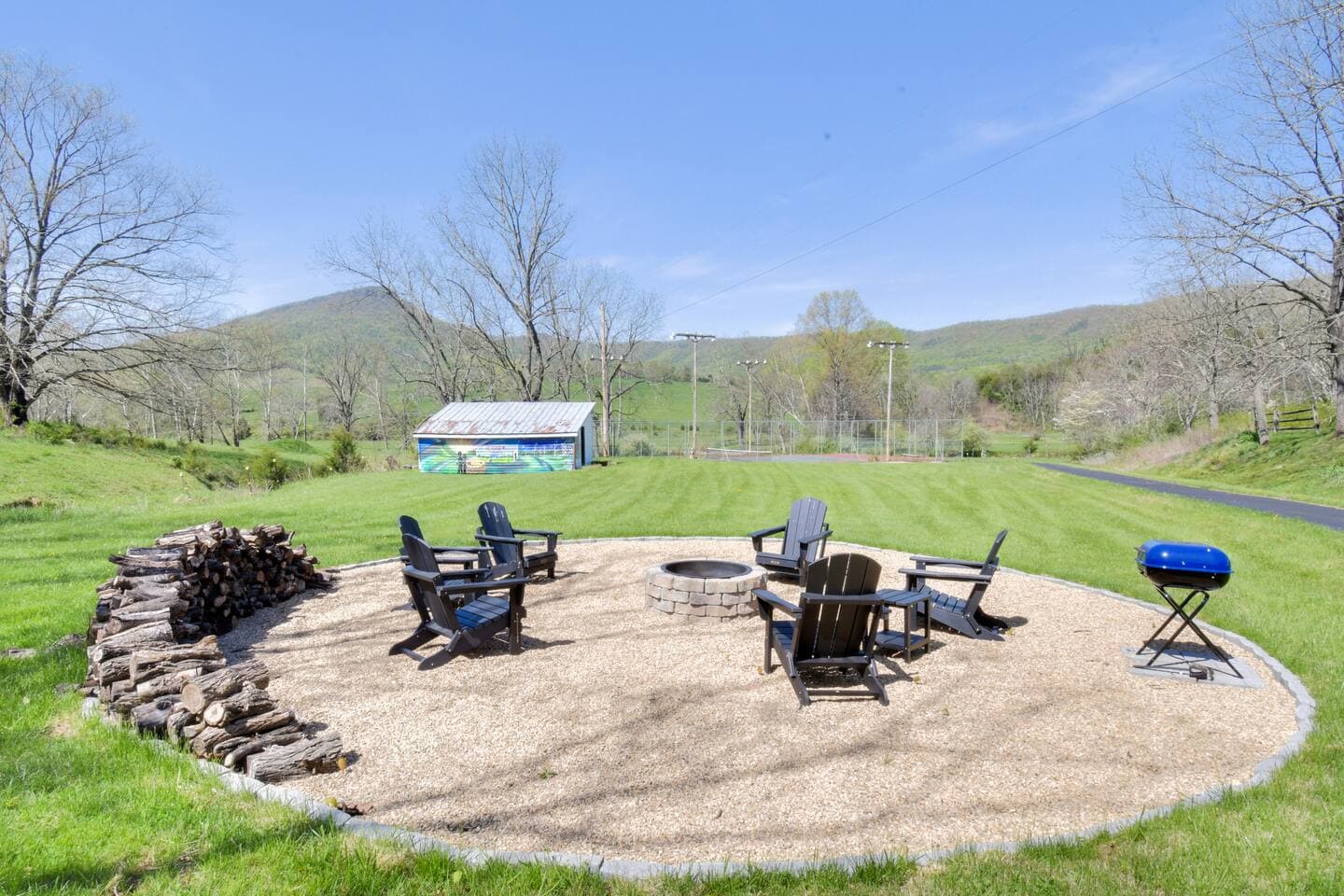 Enjoy nights under the stars at this large firepit and seating area with BBQ grill.  Daytime views of Jump Mountain and the custom mural by Ashton Hill